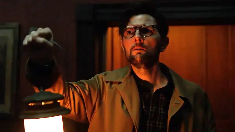 Adam Scott's Ohm looking worried while holding a lantern in Hokum