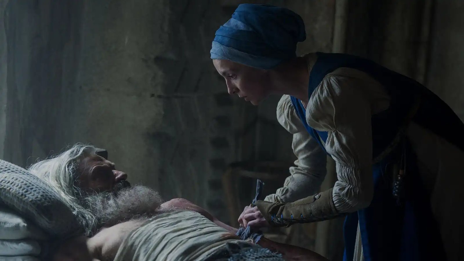 Jodie Comer's Sister Brigid tending to Hugh Jackman's Robin while in bed in The Death of Robin Hood